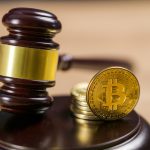 Photo of Bitcoin Regulation. BTC crypto coin and gavel on a desk.