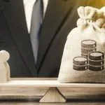 Businessman balancing Money over people