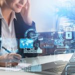 Businesswoman taking down notes while using computer with security