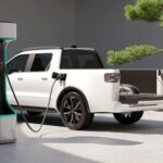 White Electric Pickup Truck connected to charging station