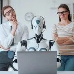 business people supervising an AI robot working in the office. Person with emotional intelligence and AI