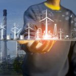 Man holding digital tablet for developing clean energy such as wind energy for energy sustainability.