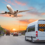 Mini bus drives along the highway among other cars in the evening in the sunset sky