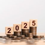 2025 new year goal plan action with 2025 in wooden cube with pile of growing coins