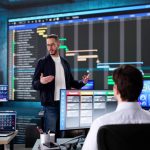 Multiracial executive training room presenting data