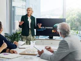 Presentation, paperwork and board directors in office with team for AI governance system.