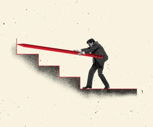 Businessman pushing giant red pencil up staircase symbol of challenge strategy and persistence in career.