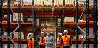 Logistics manager explaining and delegating operations to warehouse workers. Solve SMB Capacity Challenges